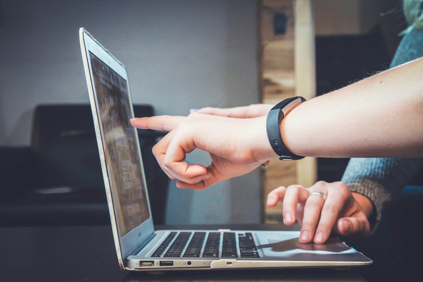 Two people reviewing a laptop together at a shared desk
